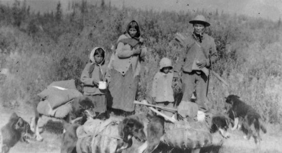 Indians and pack dogs on way to 12 Mile, c1912.