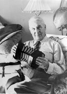 Robert Service with his concertina, c1950