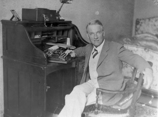 Robert Service at his desk in Monte Carlo, c1930.