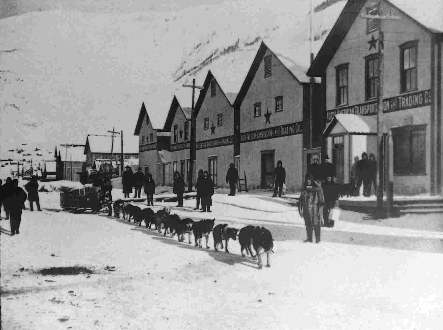 Front Street, Dawson. Team of Malamute Dogs Starting to the Mines, c1898