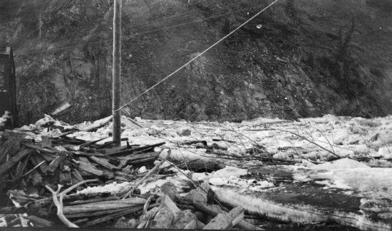 Logs, Ice and Debris up against a Bridge, c1913.