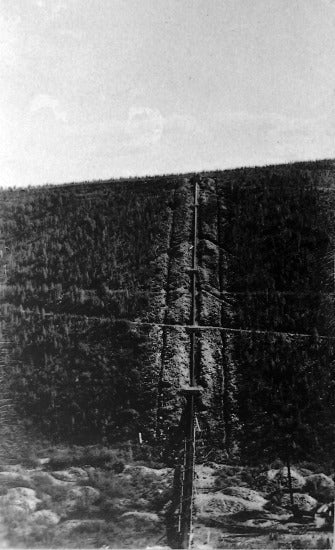 Looking South across Adams Gulch along syphon of Yukon Ditch, 1909