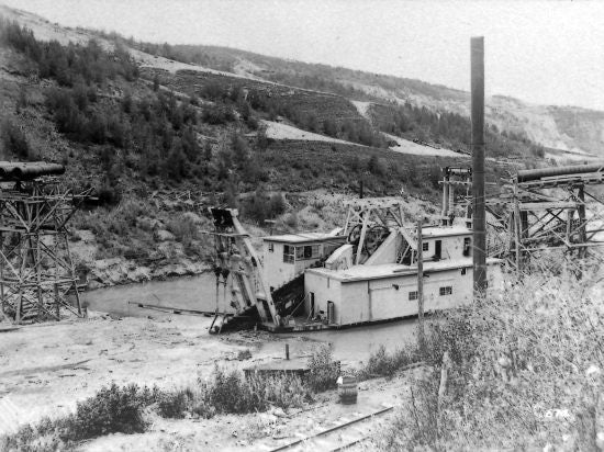 Yukon Gold Company Dredge No. 5 Working Under the Bonanza Syphon of the Yukon Ditch, 1911.