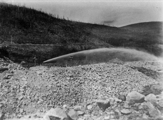 Hydraulicking the Tailings from Yukon Gold Company Dredge No. 2 at 59 Below Discovery, Bonanza Creek, c1910.
