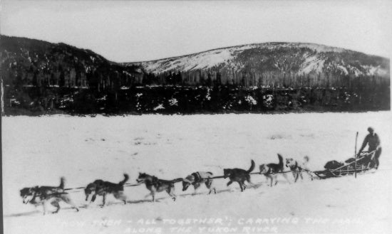 Now Then - All Together; Carrying the Mail Along the Yukon River, c1931.
