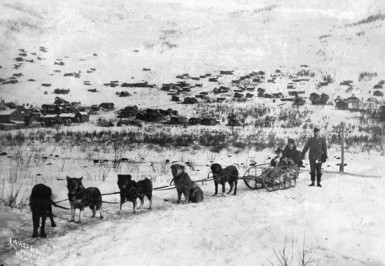 Travelling by Dog Sled, c1898.