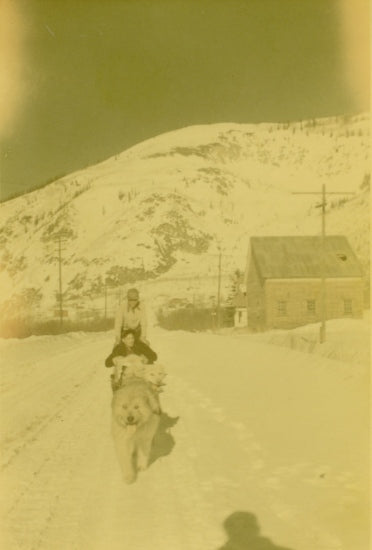 Travelling by Dog Sled on Front Street, 1951.